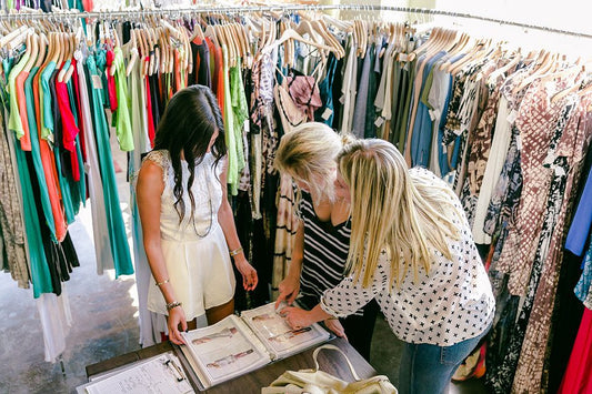 women buying and selectin clothing